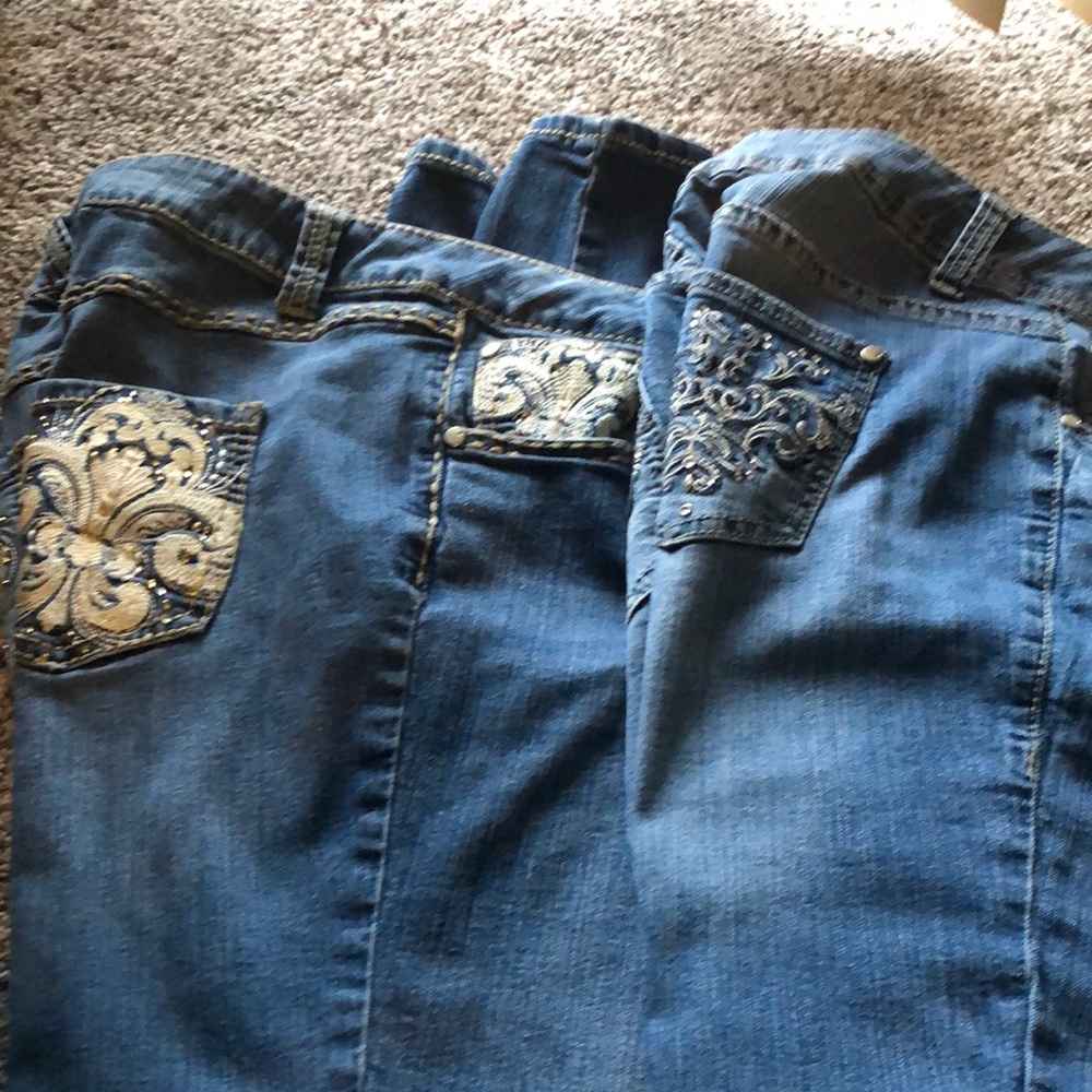 2 pairs of jeans with detailing on back pockets